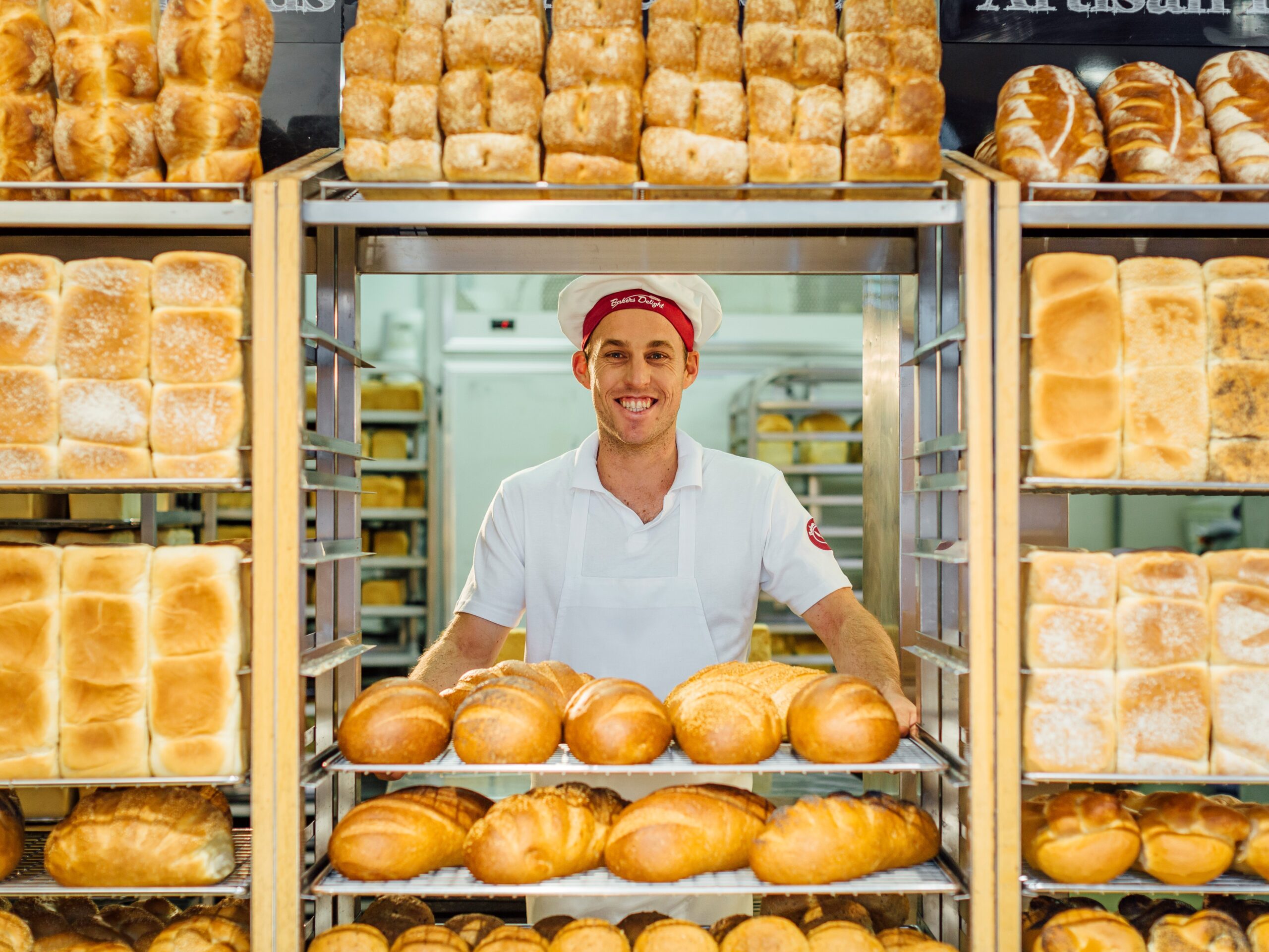 https://franchisebusiness.com.au/wp-content/uploads/2022/02/Bakers-Delight-wall-of-bread-scaled.jpg